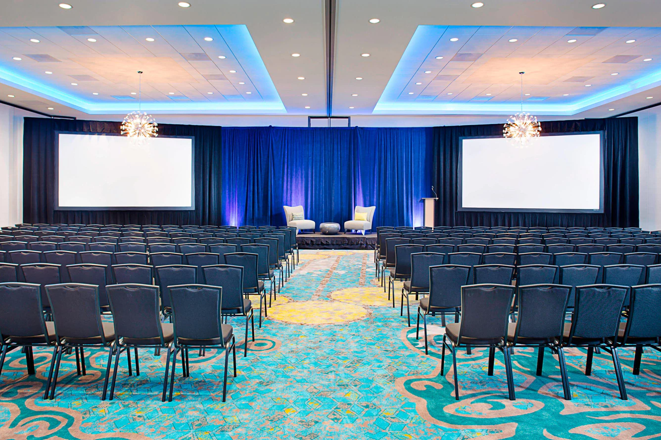 The conference room at the Courtyard by Marriott Dallas Carrollton, set with a stage and screens